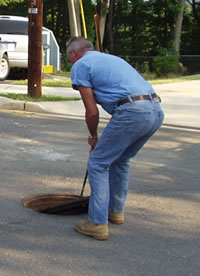 Opening a sewer manhole